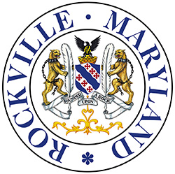 Rockville city seal, featuring red crosses and blue waves of a coat of arms, the rock hawk, gold and black escutcheon, a mural crown, quills, and bobcats with broken chains.