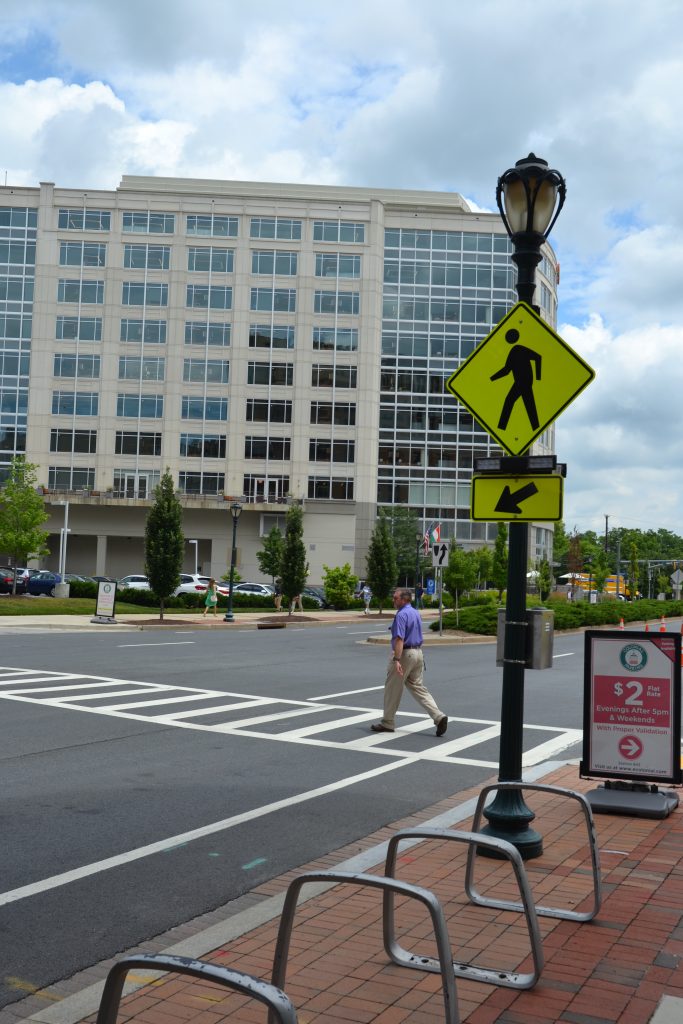 Photo of crosswalk and pedestrian-activated flashing device at East Middle Lane and Helen Heneghan Way in Rockville Town Center.