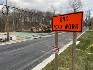 Photo of Baltimore Road construction with End Road Work sign and construction equipment along the roadside.