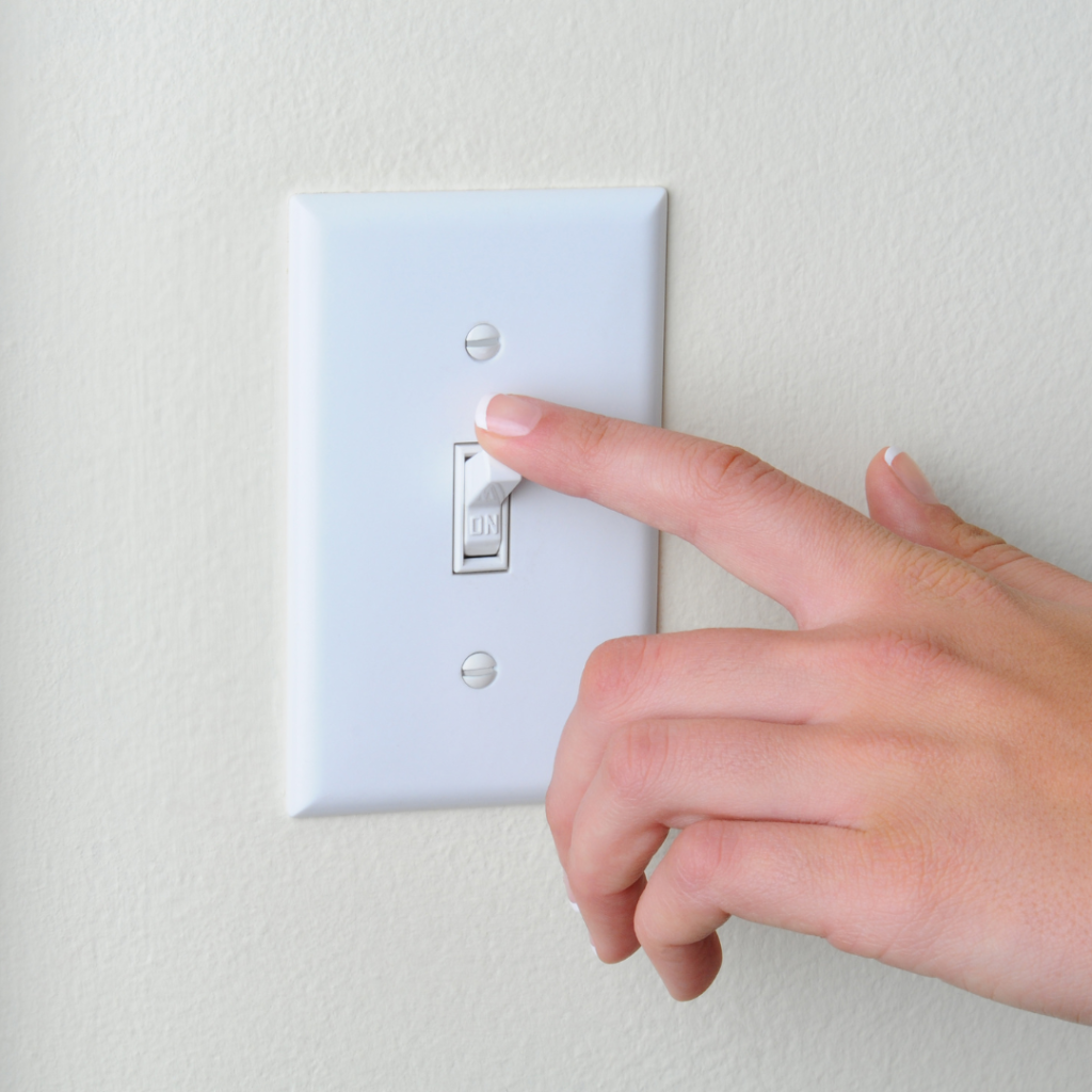 Hand on a light switch