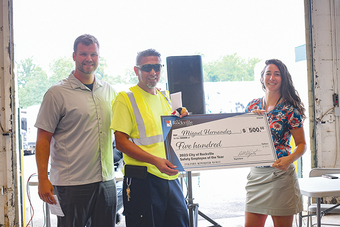 Miguel Hernandez receiving a $500 check