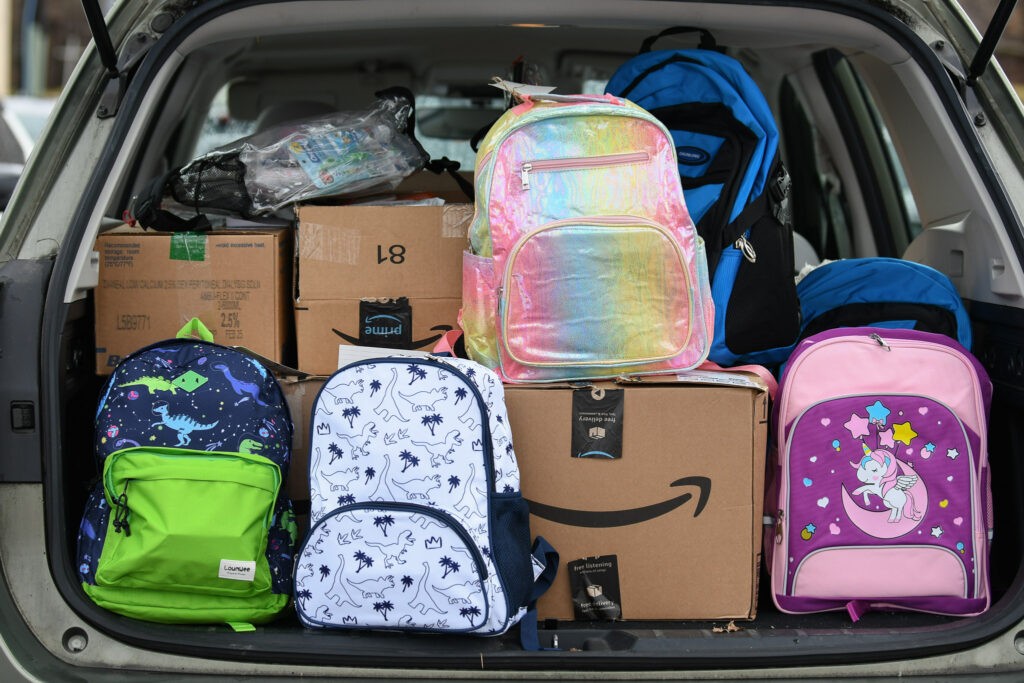 Boxes of backpacks in the trunk of a car