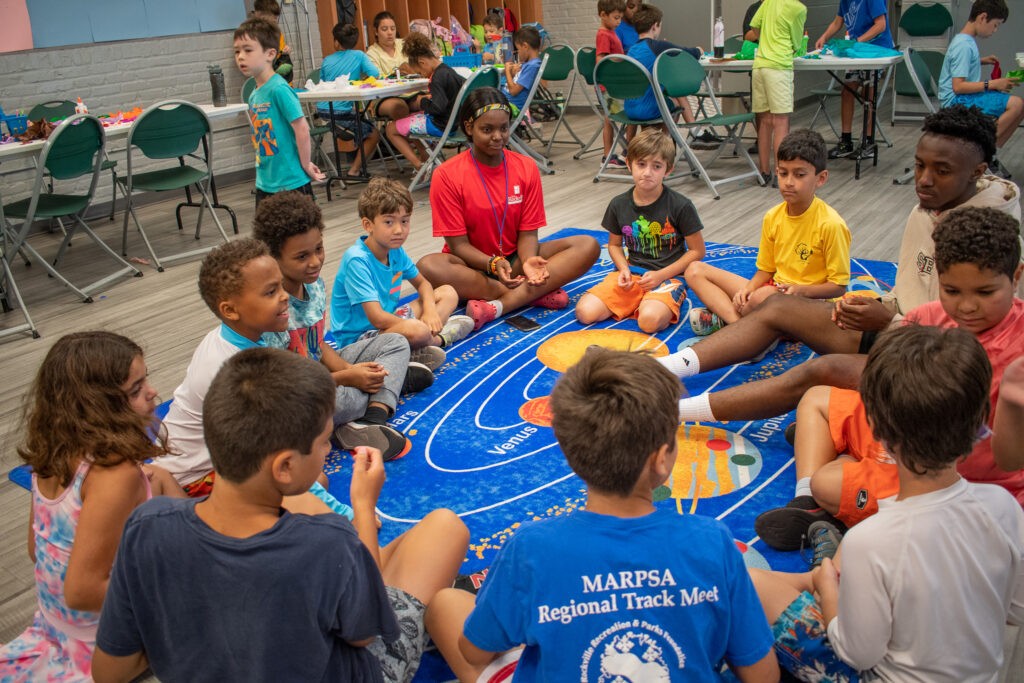 Kids playing a game in a circle at summer camp