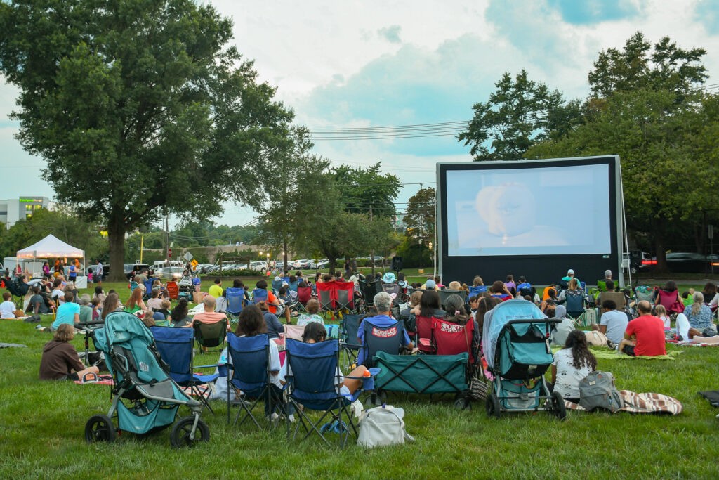 Community members watching a movie in a Rockville park